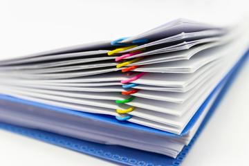 close up of Stack of papers files piles of unfinished documents achieves with paper clips