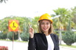 © oqba - woman Malay Chinese worker engineer management hard safety hat helmet at construction site pointing up