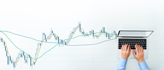 Poster - Stock market analysis. Candlestick chart and laptop. Top view of using laptop for trading.