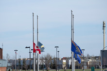 Canadian Flag And Other Flags Flying At Half Mast To Pay Respects