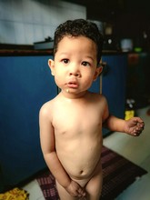 Portrait Of Naked Boy Standing At Home