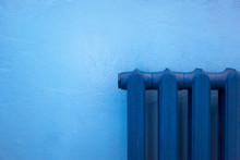 Cast Iron Blue Radiator For Heating Hanging On The Wall.
