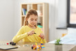 © Syda Productions - children, technology and science concept - happy girl playing with robotics kit at home