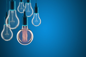 idea and teamwork concept - vintage incandescent bulbs on color background