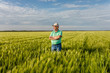 © Zoran Zeremski - Portrait of smiling senior farmer standing in in wheat field.