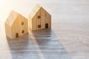 Wall Mural - Model house on wooden background sunlight .investment insurance and home purchase mortgage concept