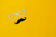 © osabee - Table top view Happy Fathers day holiday background concept.Flat lay  photo booth prop the eye glasses and mustache on modern rustic yellow paper with copy space for creative design world.vintage.
