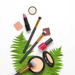 beauty cosmetic makeup background. fashion woman make up product, brushes, lipstick, tropical leaf, 