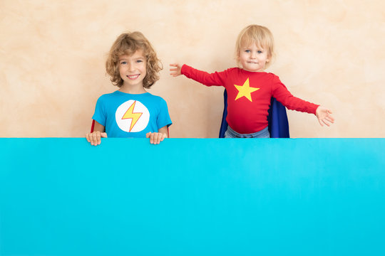 superheroes children holding blue banner blank