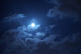 The moon night view with the round moon and clouds in the sky
