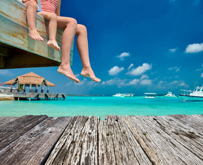 Poster - Toddler boy with mother sitting on wooden jetty