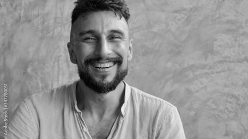 Cuadros en Lienzo Portrait of a happy adult smiling handsome man in 30's looking in camera, Indoo