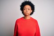 © Krakenimages.com - Young beautiful African American afro woman with curly hair wearing red casual sweater puffing cheeks with funny face. Mouth inflated with air, crazy expression.