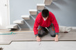 © raulbachiller - repairman laying flooring