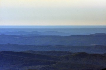 horizon seen from above in top of the mountain on summer day with white clouds and green grass