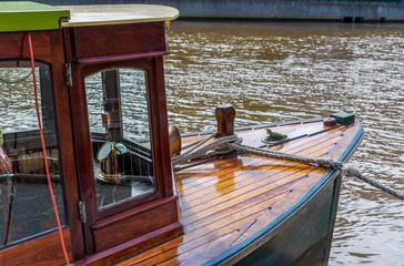 A vintage sightseeing tourist boat is tied the the jetty on the Yarra River at Southbank, Melbourne, Australia