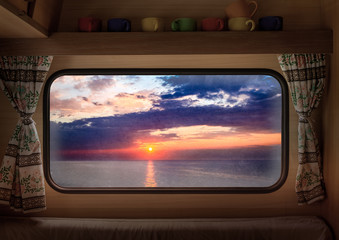 Wall Mural - View from window camper of stunning dusk over calm ocean