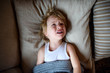 © Halfpoint - Top view of crying small sick boy in bed indoors at home.