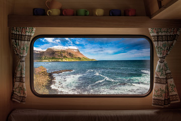 Wall Mural - arctic sea and coastline in iceland, view from camper window