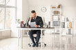 © Pixel-Shot - Male judge working at table in office