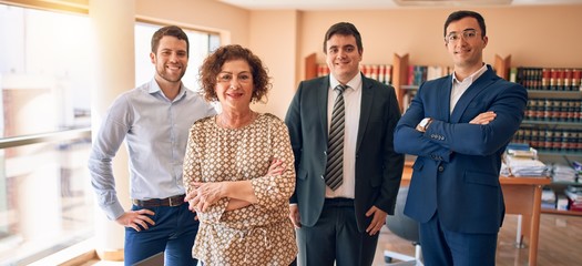 Wall Mural - Business lawyers workers meeting at law firm office. Professional executive partners working on finance strategry at the workplace. Standing confident looking at the camera.