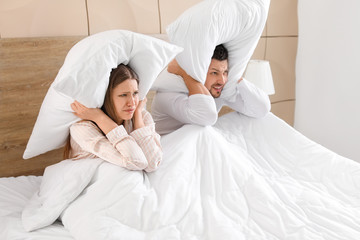 Canvas Print - Young couple cannot sleep because of rowdy neighbours