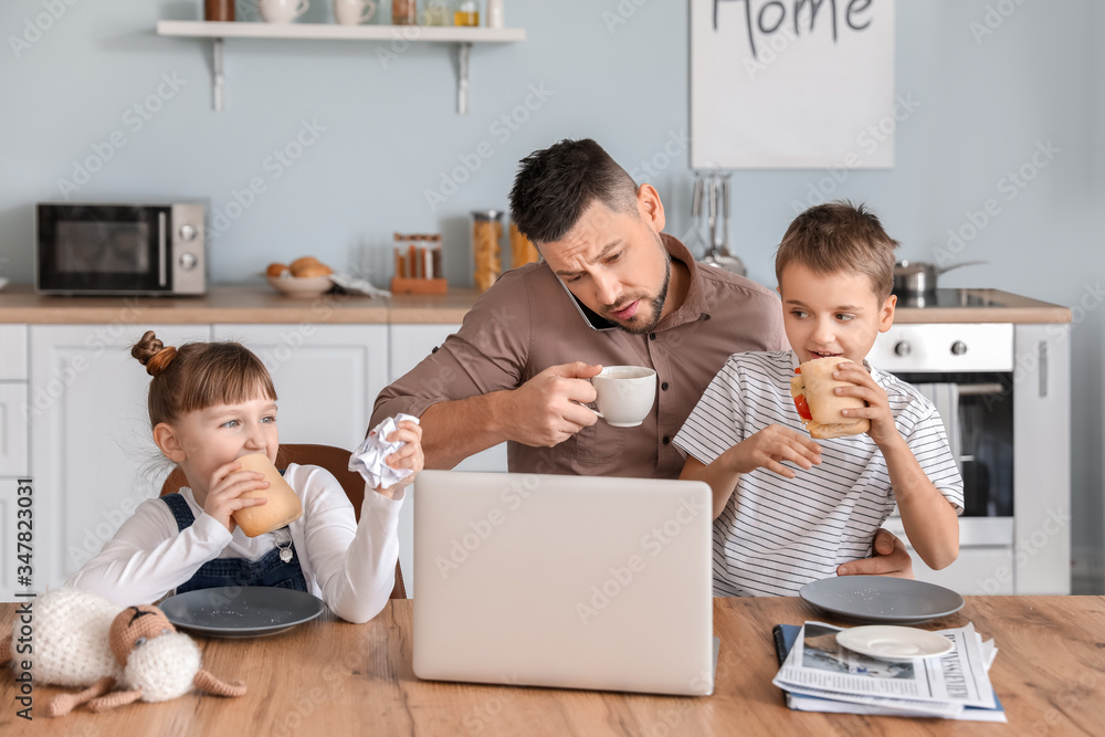 Working father with naughty little children at home