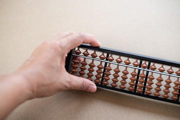 Wall Mural - Close up hand using abacus.