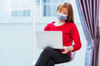 © sorapop - Asian young business woman wear red t-shirt sitting on chair wearing face mask protective working from home office using laptop computer he quarantines disease coronavirus or COVID-19 with copy space