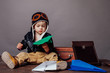 © dmitriisimakov - Boy in pilot's suit plays with paper planes