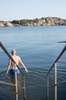 © viktor holm - Man going for a swim in the swedish archipelago