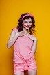 Portrait of a beautiful fashionable pinup woman with pink clothes