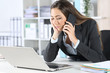 © Antonioguillem - Executive calling on phone waiting on hold at office
