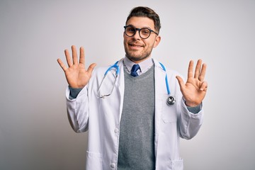 Wall Mural - Young doctor man with blue eyes wearing medical coat and stethoscope over isolated background showing and pointing up with fingers number nine while smiling confident and happy.