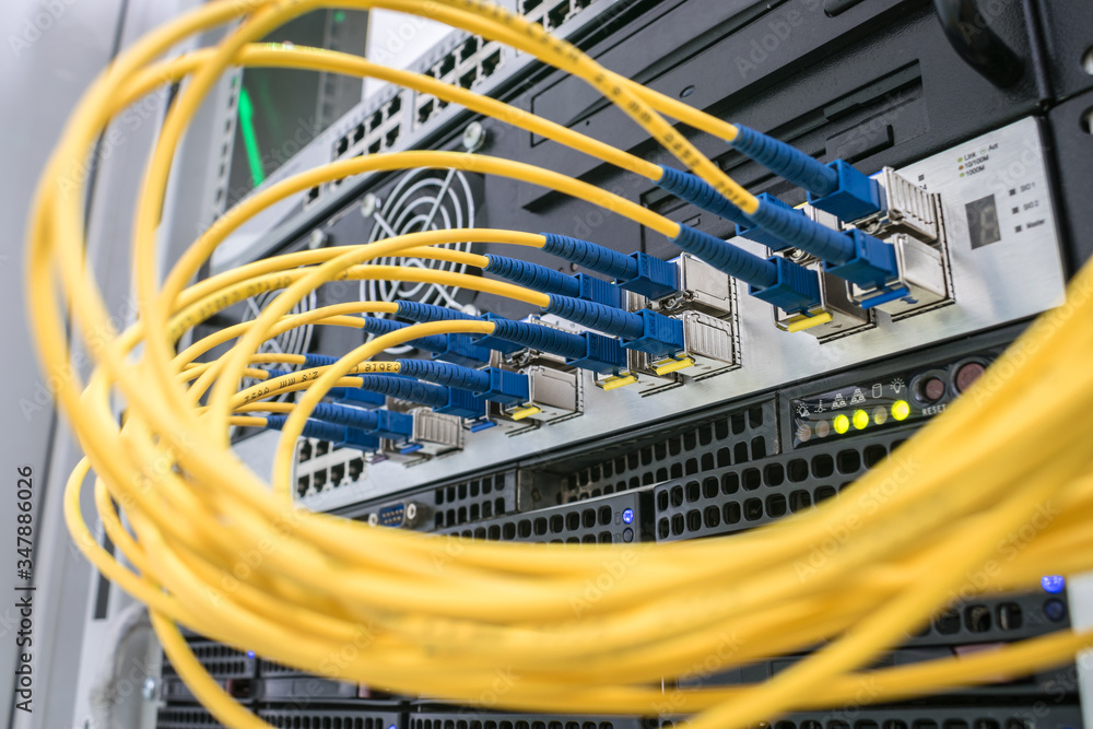 A bunch of fiber-optic Internet wires are connected to the router ...
