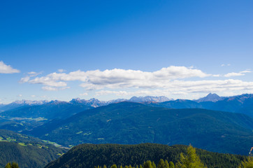 holidays in the mountains, living in the mountains, mountain peaks in the sunlight, green woods and rocks