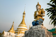 Praying Statue Before Golden Dome Temple, Mae Hong Son, Thailand