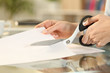 © PheelingsMedia - Woman hands with scissors cutting paper on a desk