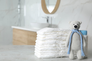 Wall Mural - stack of diapers and baby accessories on counter in bathroom. space for text