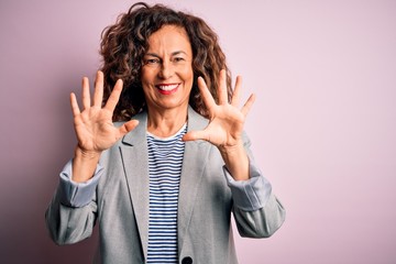 Poster - Middle age beautiful businesswoman wearing elegant jacket over isolated pink background showing and pointing up with fingers number ten while smiling confident and happy.