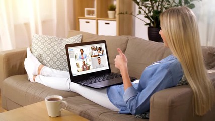 Sticker - virtual communication, technology and people concept - smiling woman having group video chat with her friends on laptop computer sitting on sofa at home