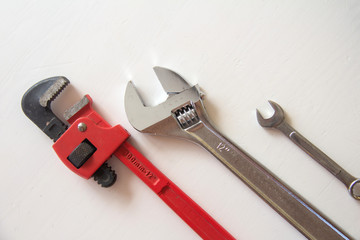 Wall Mural - Male tools. close up Happy Father's Day inscription with Mechanic hand hold spanner tool on white background. Greetings and presents. white card with the ability to insert text, copyspace, 