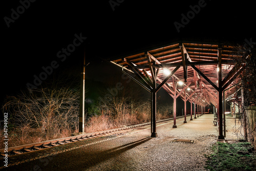 Fotomural Bystrzyca Klodzka, a railway station illuminated at night.