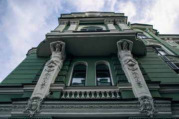 Wall Mural - View of the beautiful facade with the statues of the green house. The houses of St. Petersburg.Windows of a big city.