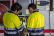 © Javier De La Torre/ADDICTIVE STOCK - Back view of group of professional male technicians with electric tools repairing and checking equipment while working in building