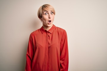 Sticker - Young beautiful business blonde woman with short hair standing over isolated background afraid and shocked with surprise expression, fear and excited face.