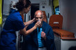 © Anna Kosolapova - Paramedic presses an oxygen mask to an injured man's face