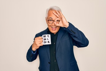 Sticker - Middle age senior grey-haired man drinking a coffee on best dad cup over isolated background with happy face smiling doing ok sign with hand on eye looking through fingers