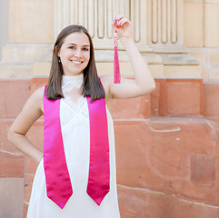 Graduation 2020 with a young woman holding her tassel.