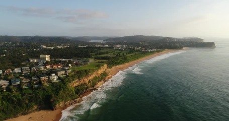 Poster - Aerial panning to open Pacific ocean from scenic coast of Sydney Northern beaches at sunrise.
